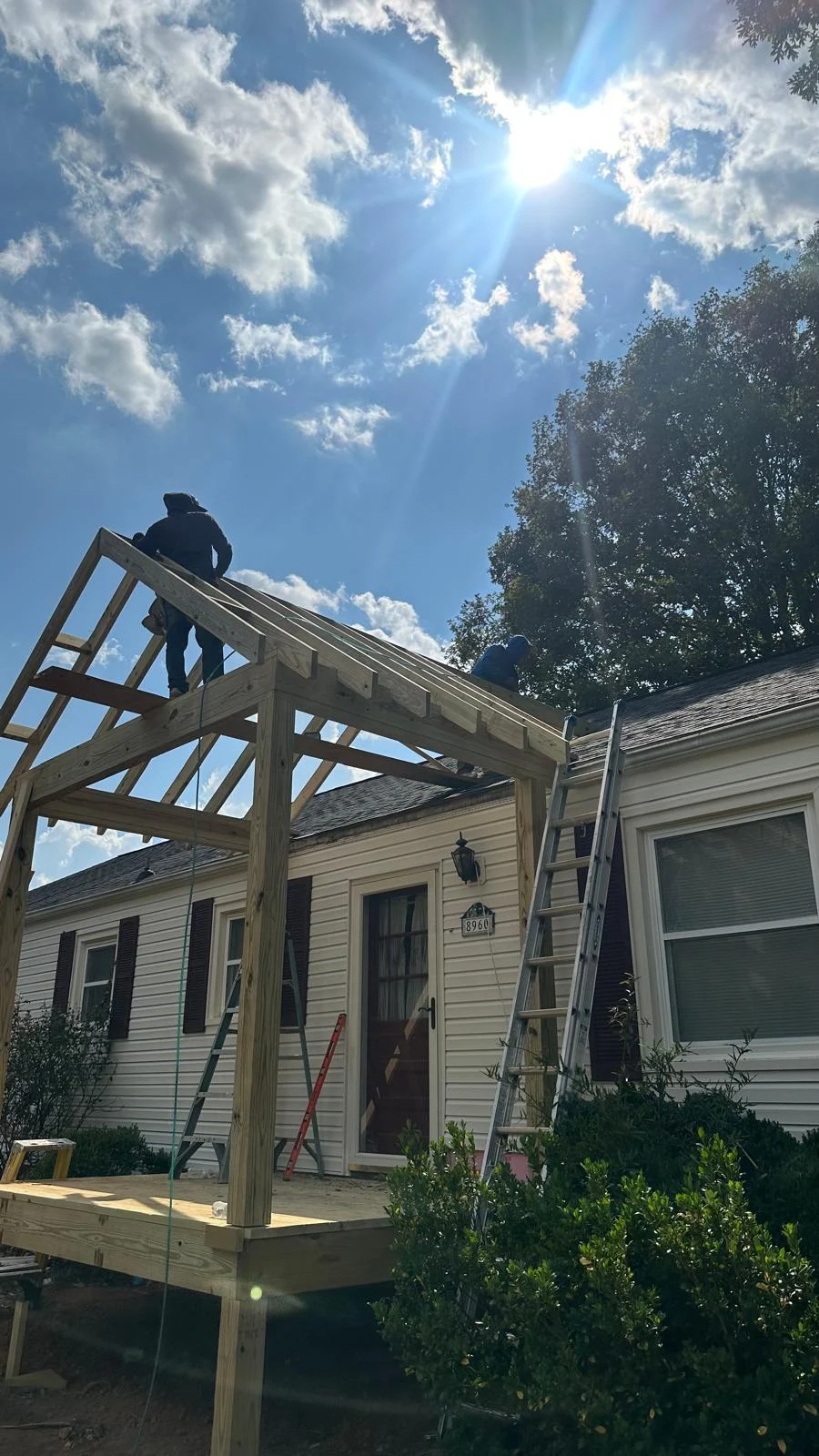 Covered porch roof framing in progress by NGRE Home Improvements