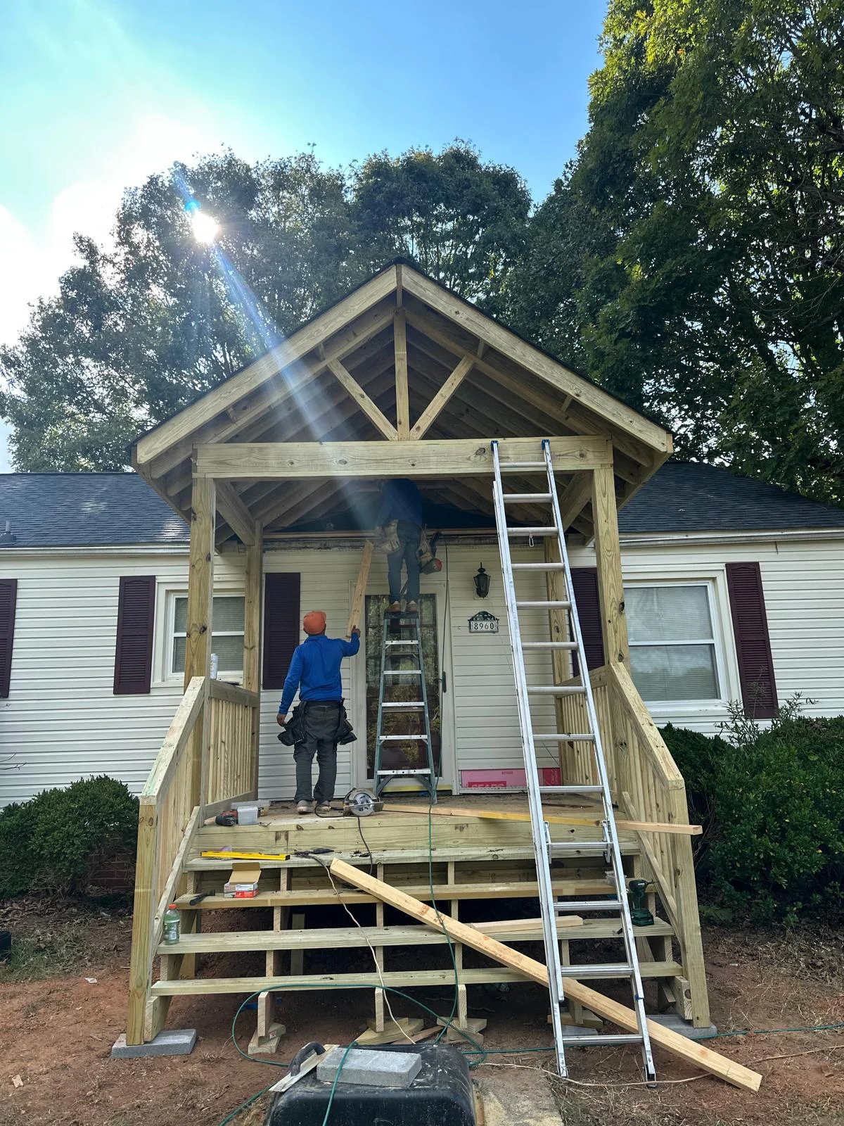 Covered front porch roof structure in progress by NGRE Home Improvements